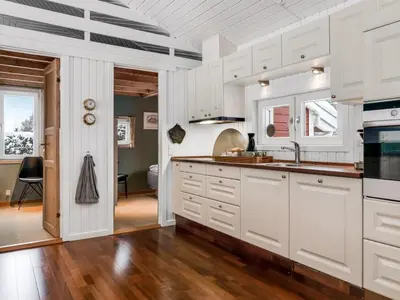 a kitchen with white cabinets and a sink at Holiday Home Valda - 1-5km from the sea by Interhome in Saltum