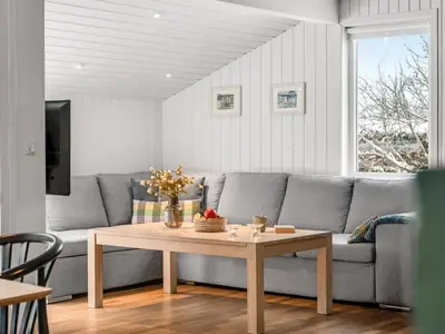 a living room with a couch and a table at Holiday Home Valda - 1-5km from the sea by Interhome in Saltum