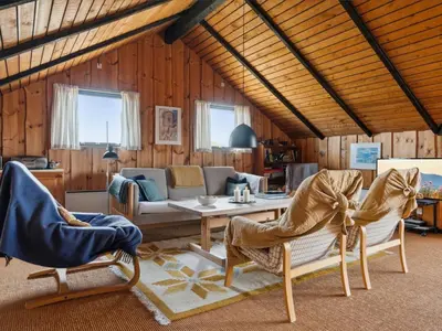 a living room with a table and chairs at Holiday Home Henri - 500m from the sea by Interhome in Fjerritslev