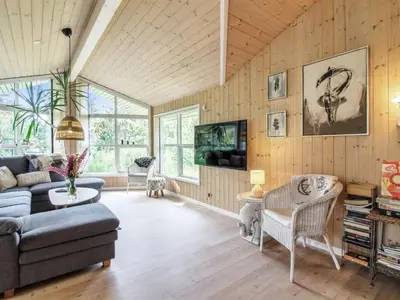 a living room with a couch and a tv at Holiday Home Arlett - 950m from the sea by Interhome in Fjerritslev
