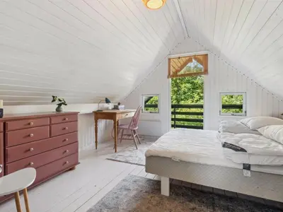a bedroom with a bed and a desk and a window at Holiday Home Nadia - 300m to the fjord by Interhome in Fur
