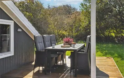 a patio with a table and chairs on a deck at Amazing Home In Vestervig With Kitchen in Vestervig