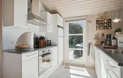 a kitchen with white cabinets and a sink and a window at Amazing Home In Vestervig With Kitchen in Vestervig