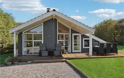 a small house with a deck and chairs at Amazing Home In Vestervig With Kitchen in Vestervig