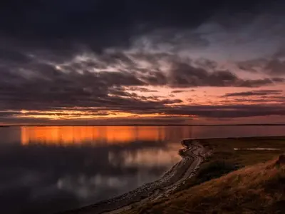 a sunset over a body of water with a cloudy sky at 6 person holiday home in Skals-By Traum in Skals
