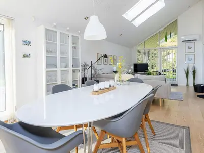 a white dining room with a white table and chairs at 4 star holiday home in Skals-By Traum in Skals