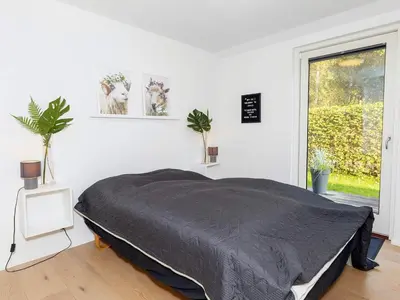 a white bedroom with a bed and a window at 4 star holiday home in Skals-By Traum in Skals