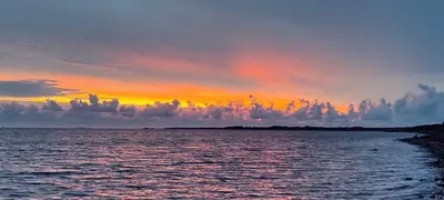 a sunset over a large body of water at Villa Vandkant in Thyholm
