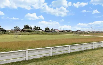 a white fence in front of a soccer field at Stunning Home In Vestervig With Kitchen in Vestervig