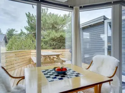 a table with a bowl of fruit on top of a balcony at Holiday Home Floria - 1-4km from the sea by Interhome in Torsted