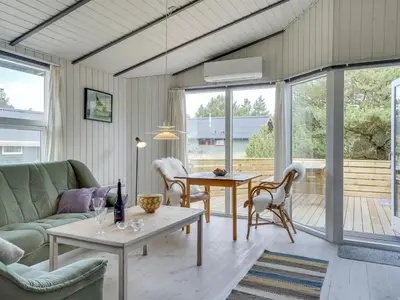 a living room with a couch and a table at Holiday Home Floria - 1-4km from the sea by Interhome in Torsted