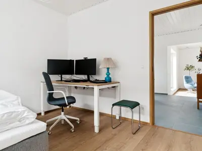 a bedroom with a desk with a computer and two chairs at Holiday Home Yakari - 1km from the sea by Interhome in Torsted