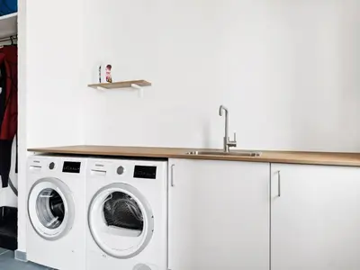 a kitchen with a washing machine and a sink at Holiday Home Yakari - 1km from the sea by Interhome in Torsted