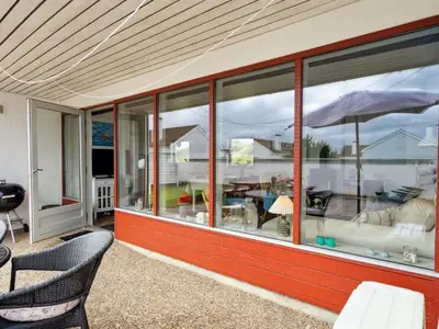 a house with large windows with a view of a patio at Holiday Home Werna - 900m from the sea by Interhome in Pandrup