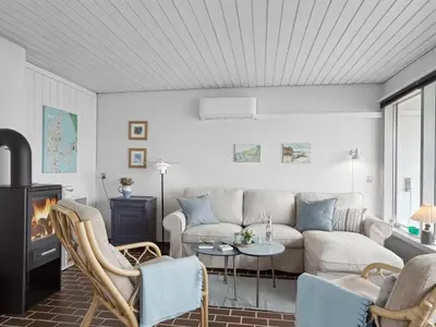 a living room with a couch and a fireplace at Holiday Home Werna - 900m from the sea by Interhome in Pandrup