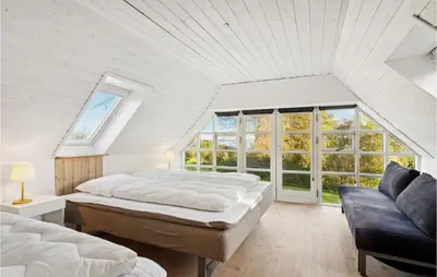 a bedroom with two beds and a couch at 3 Bedroom Cozy Home In Løgstrup in Knud