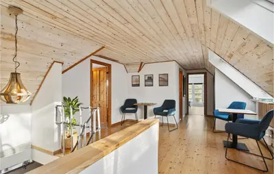 an open living room with a wooden ceiling at 3 Bedroom Cozy Home In Løgstrup in Knud