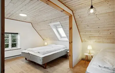 a bedroom with two beds in a attic at 3 Bedroom Cozy Home In Løgstrup in Knud