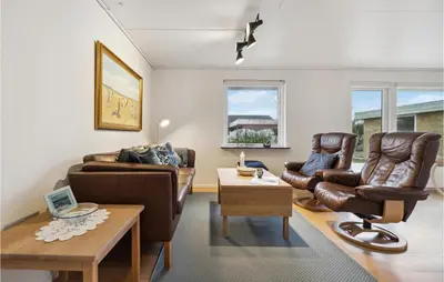 a living room with leather furniture and a table at 3 Bedroom Lovely Home In Vestervig in Vestervig