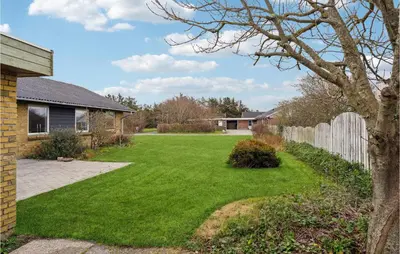 a yard with a fence and green grass at 3 Bedroom Lovely Home In Vestervig in Vestervig