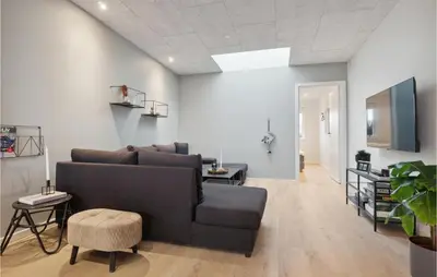 a living room with a couch and a tv at Awesome Home In Thisted With Sauna in Thisted