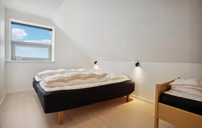 a bedroom with two beds and a window at Beautiful Home In Nykøbing M With Wifi in Nykøbing Mors