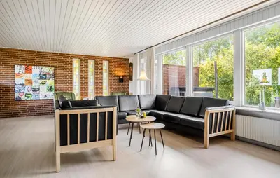 a living room with a black couch and a table at Beautiful Home In Nykøbing M With Wifi in Nykøbing Mors