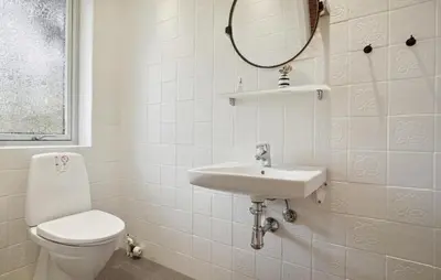a bathroom with a toilet and a sink and a mirror at Beautiful Home In Nykøbing M With Wifi in Nykøbing Mors