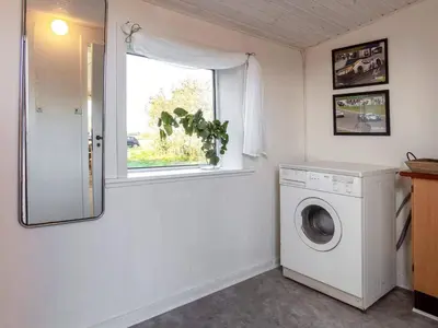 a laundry room with a washing machine and a window at 8 person holiday home in Lemvig-By Traum in Lemvig