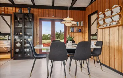 a dining room with a table and chairs at Nice Home In Harboøre With Wifi in Harboør