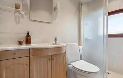 a bathroom with a toilet and a sink and a shower at Nice Home In Harboøre With Wifi in Harboør