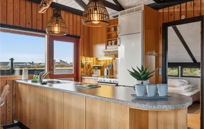 a kitchen with a counter with a sink and a refrigerator at Nice Home In Harboøre With Wifi in Harboør