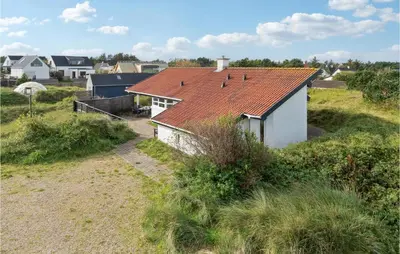 a white house with a red roof on a field at Pet Friendly Home In Thisted With Wifi in Thisted