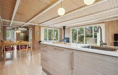 a kitchen with a sink and a dining room at Nice Home In Thyholm With Wifi in Thyholm