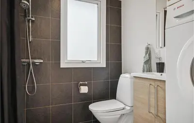 a bathroom with a toilet and a shower at Nice Home In Thyholm With Wifi in Thyholm