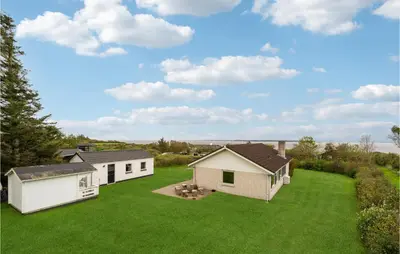 a large yard with two white buildings and green grass at 3 Bedroom Beautiful Home In Spøttrup in Spottrup