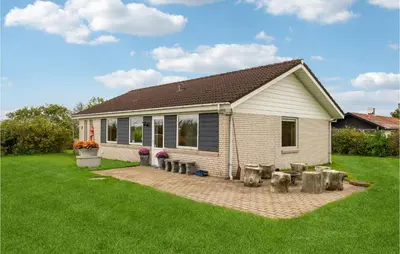 a small white house with a yard with a lawn at 3 Bedroom Beautiful Home In Spøttrup in Spottrup