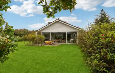 a house with a yard with green grass at 3 Bedroom Beautiful Home In Spøttrup in Spottrup