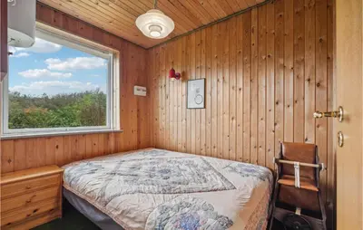 a bedroom with a bed and a window at 3 Bedroom Beautiful Home In Spøttrup in Spottrup