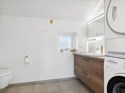 a white bathroom with a toilet and a sink at Holiday Home Blaguna - 600m from the sea by Interhome in Torsted