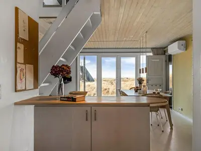 a kitchen with a counter with a large window at Holiday Home Pauli - 350m from the sea by Interhome in Pandrup
