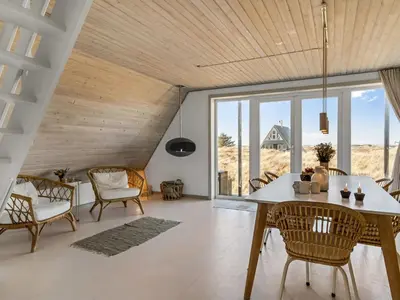 a dining room with a table and chairs at Holiday Home Pauli - 350m from the sea by Interhome in Pandrup