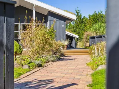 a house with a brick walkway next to a building at Holiday Home Ofelia - 2-5km from the sea by Interhome in Blokhus
