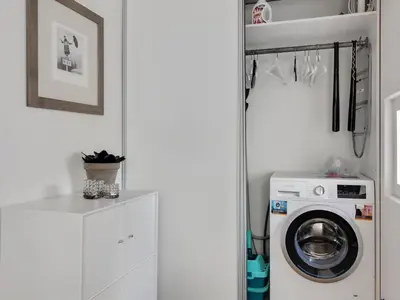 a white laundry room with a washer and dryer at Apartment Virpi - 1km from the sea by Interhome in Blokhus