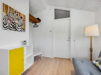 a living room with a couch and a desk at Holiday Home Gebko - 150m from the sea by Interhome in Saltum