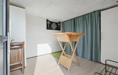 a table in a room with a green curtain at Cozy Home In Lemvig With House Sea View in Lemvig