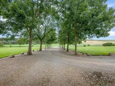 a gravel road with trees in the middle of a field at 5 star holiday home in Spøttrup-By Traum in Spottrup