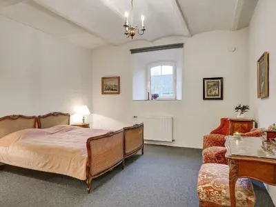 a bedroom with a bed and a couch and a window at 5 star holiday home in Spøttrup-By Traum in Spottrup