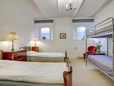 a bedroom with two beds and a bunk bed at 5 star holiday home in Spøttrup-By Traum in Spottrup
