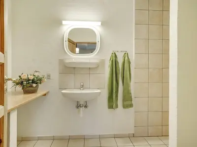 a bathroom with a sink and a mirror at 5 star holiday home in Spøttrup-By Traum in Spottrup